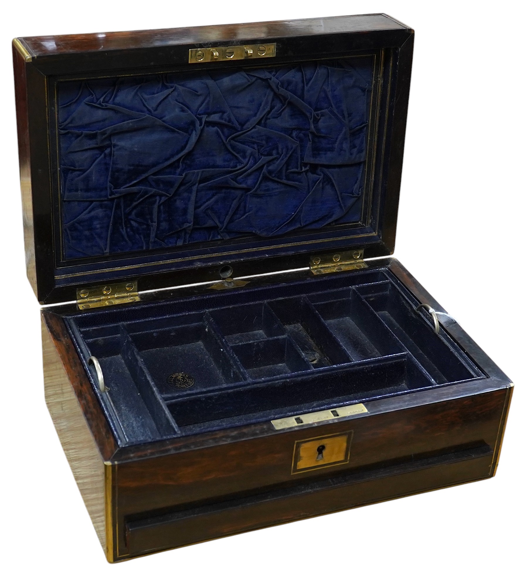 A Victorian brass bound coromandel wood jewellery casket, with velvet lined lid, a fitted leather and velvet top compartment shelf and base lower drawer. 13cm high x 28cm wide. Condition - some splits to the veneer on th